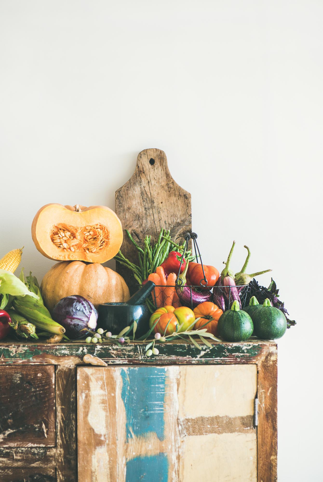 bundles of seasonal vegetables on market stall for atelier kit