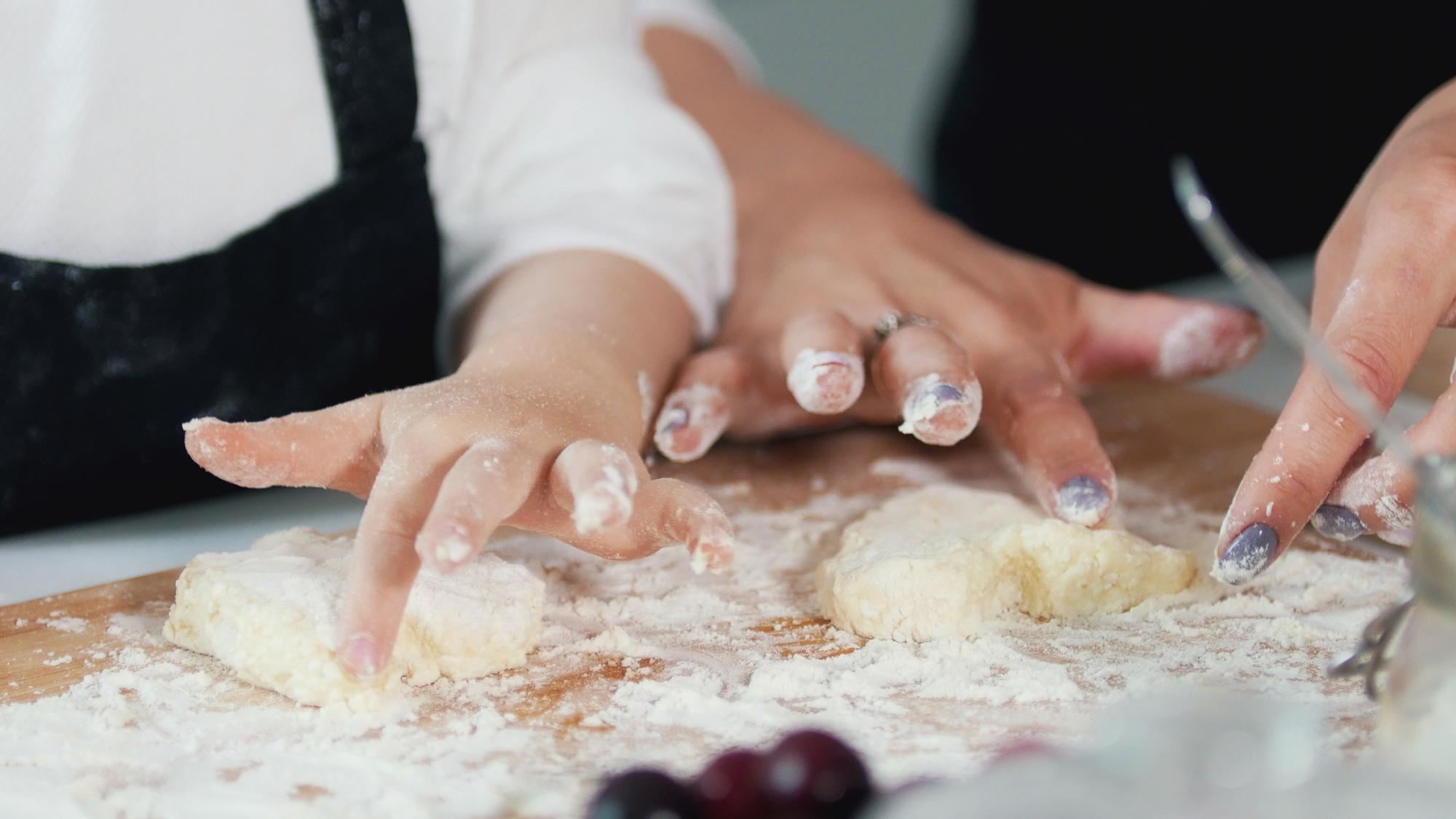 close-up of hands folding pastry in a teaching studio